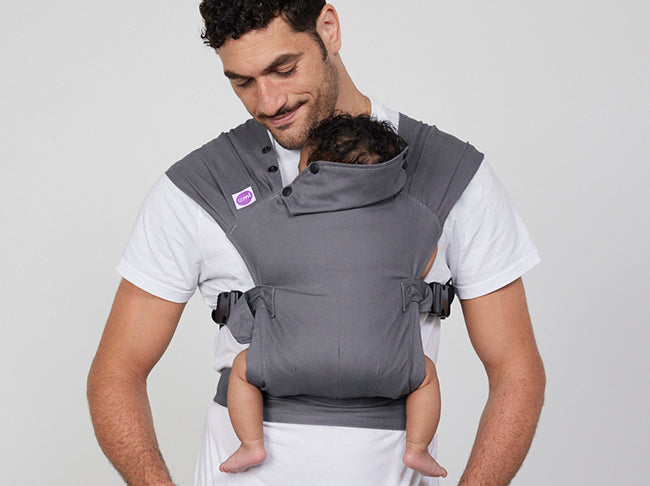 Man carries baby on his chest in Izmi Baby Carrier