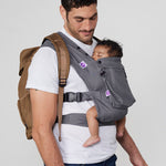 Man carries baby on his chest in Izmi Baby Carrier with Zip Pocket attached