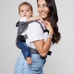 Woman carries baby on her back in Izmi Breeze Baby Carrier