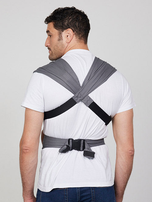 Back view of man wearing Izmi Baby Carrier showing crossed shoulder straps