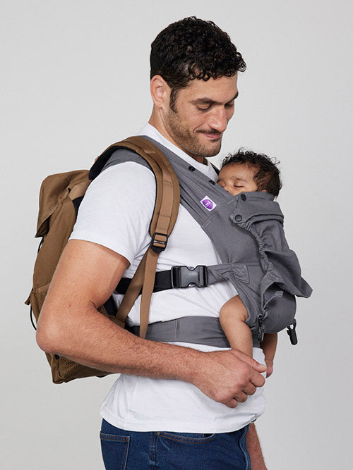 Man carries baby facing towards him in Izmi Baby Carrier