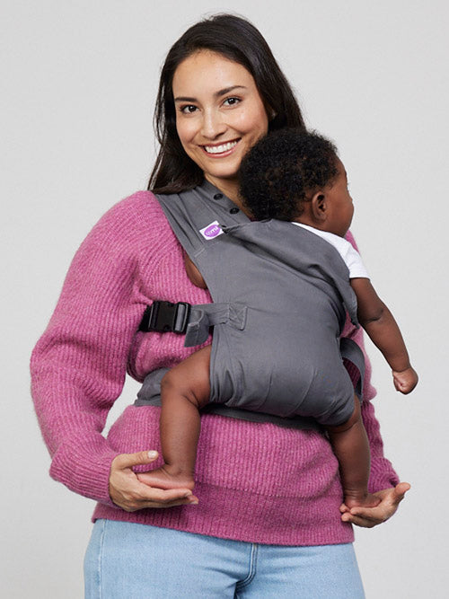 Woman carries baby on her front in Izmi Baby Carrier