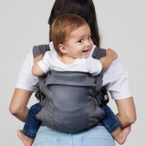 Woman carries baby on her back in Izmi Breeze Baby Carrier, back view