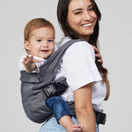 Woman carries baby on her back in Izmi Breeze Baby Carrier, side view