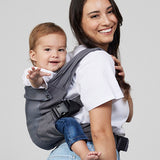 Woman carries baby on her back in Izmi Breeze Baby Carrier, side view