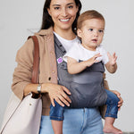 Woman carries baby facing forwards in Izmi Breeze Baby Carrier