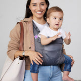 Woman carries baby facing forwards in Izmi Breeze Baby Carrier