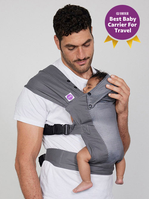 Man carries baby on his front in Izmi Breeze Baby Carrier