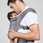 Man carries baby facing towards him in Izmi Breeze Baby Carrier, side view