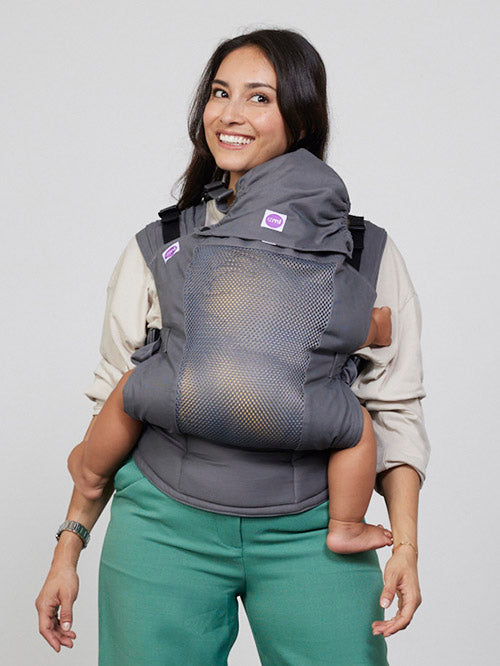 Woman carries toddler on her front in Izmi Breeze Baby Carrier with Sleep Hood