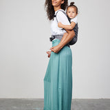 Woman carries toddler on her back in Izmi Toddler Carrier