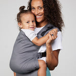 Woman carries toddler on her front in Izmi Toddler Carrier