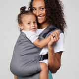 Woman carries toddler on her front in Izmi Toddler Carrier