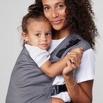 Woman carries toddler on her front in Izmi Toddler Carrier
