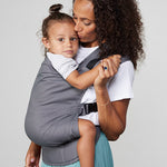 Woman carries toddler on her front in Izmi Toddler Carrier