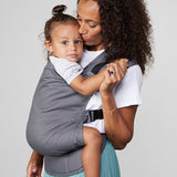 Woman carries toddler on her front in Izmi Toddler Carrier